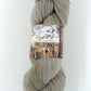 Buffalo Hills "Sand" Botanically Dyed Sport weight yarn on a Climate Beneficial Wool Base Yarn. 4 0z 3-ply skeins made and sourced in the USA. Neutral sandy shade of gray makes a great contrast for color work.